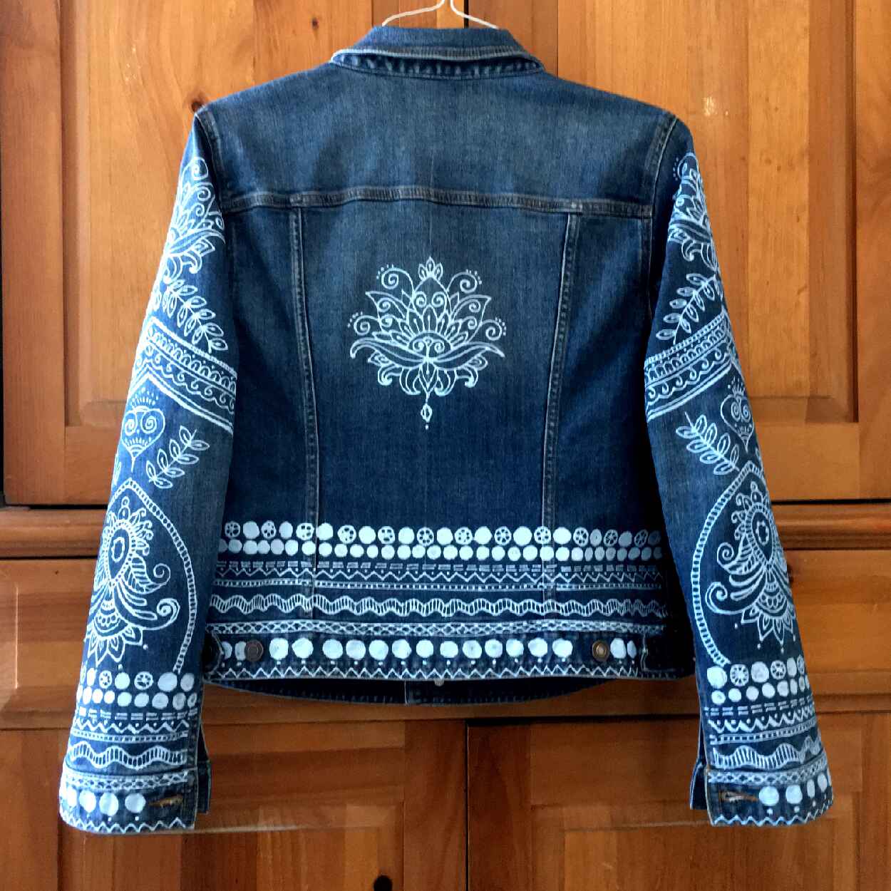 Denim Jacket with blue paint on sleves and back.